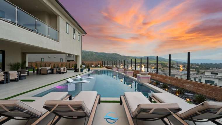 How do elevation changes impact pool design and cost_